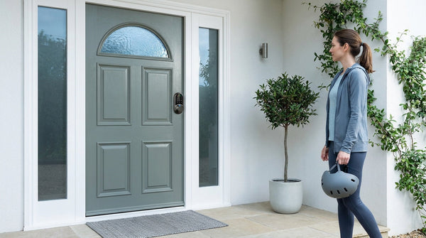 Grey-green front door with a Veise fingerprint keypad deadbolt — keypad and smart deadbolt types compared